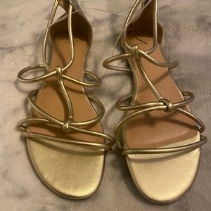 Gold strappy sandal.